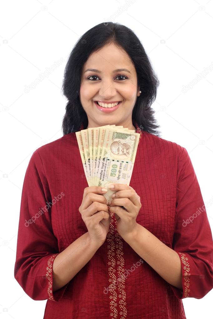 Happy young woman holding Indian currency notes 