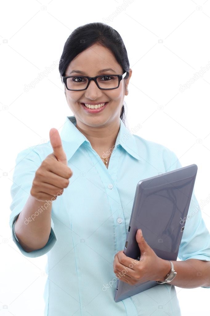 Businesswoman with tablet and making thumbs up gesture