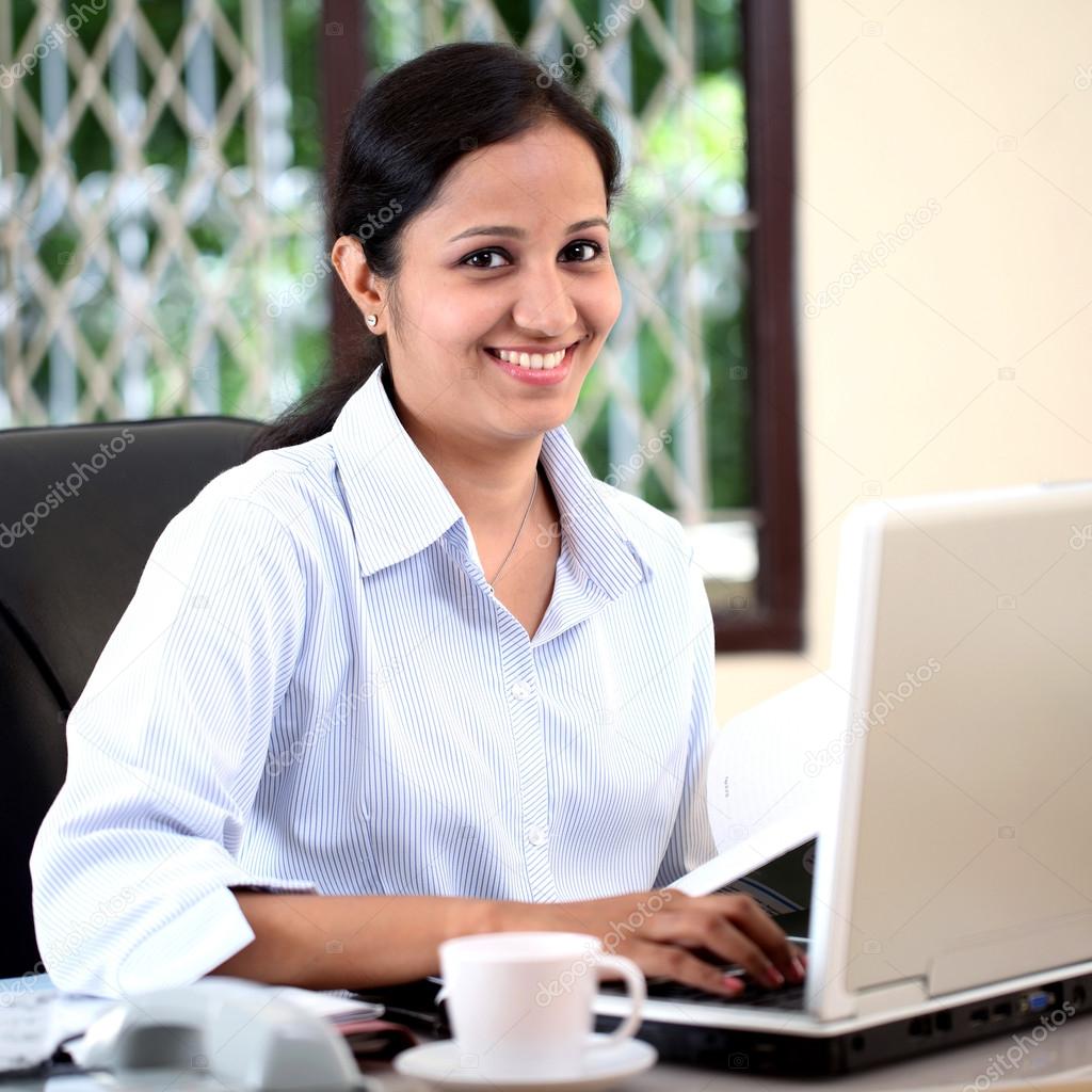 Cheerful businesswoman working on computer