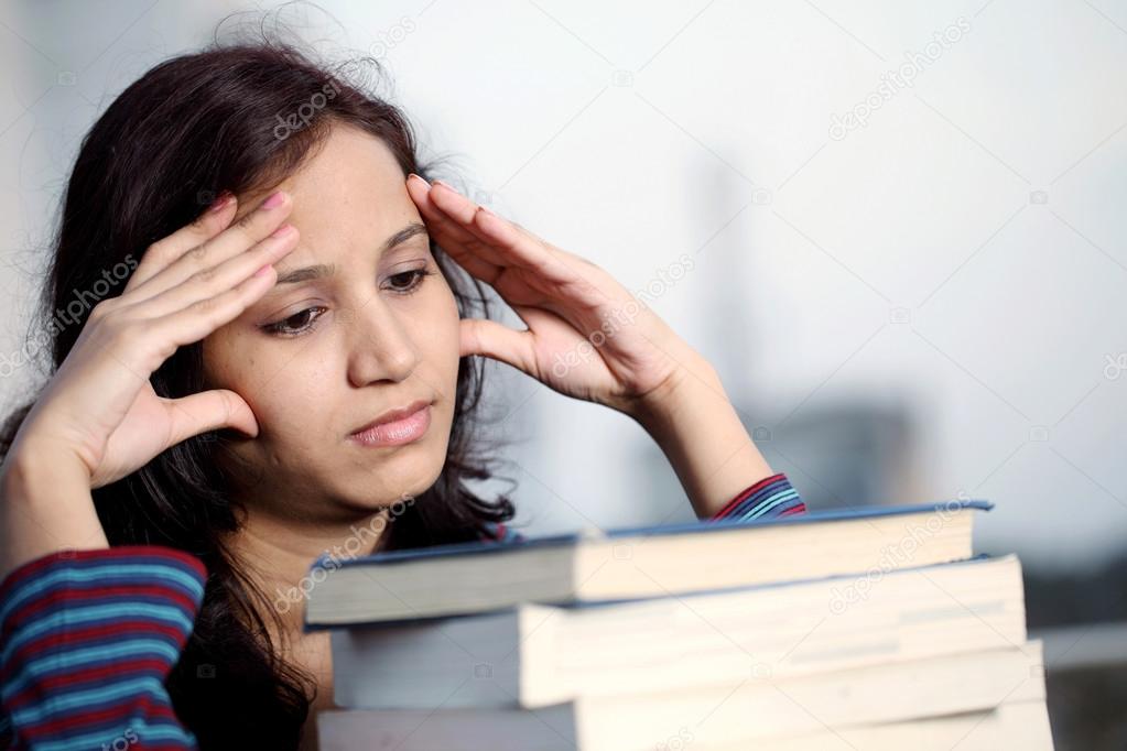 Stressed student with books