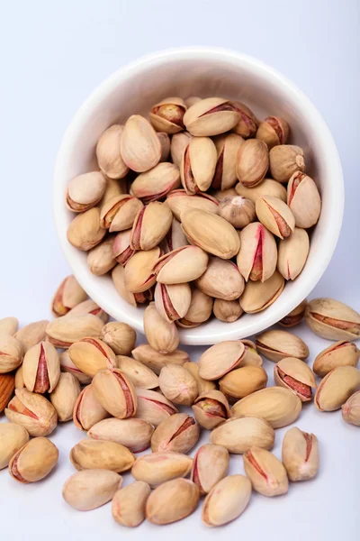 Bowl of pistachios spilled out — Stock Photo, Image