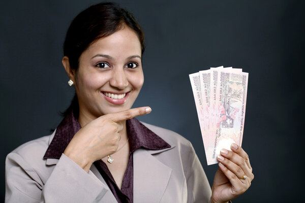 Business woman holding currency notes