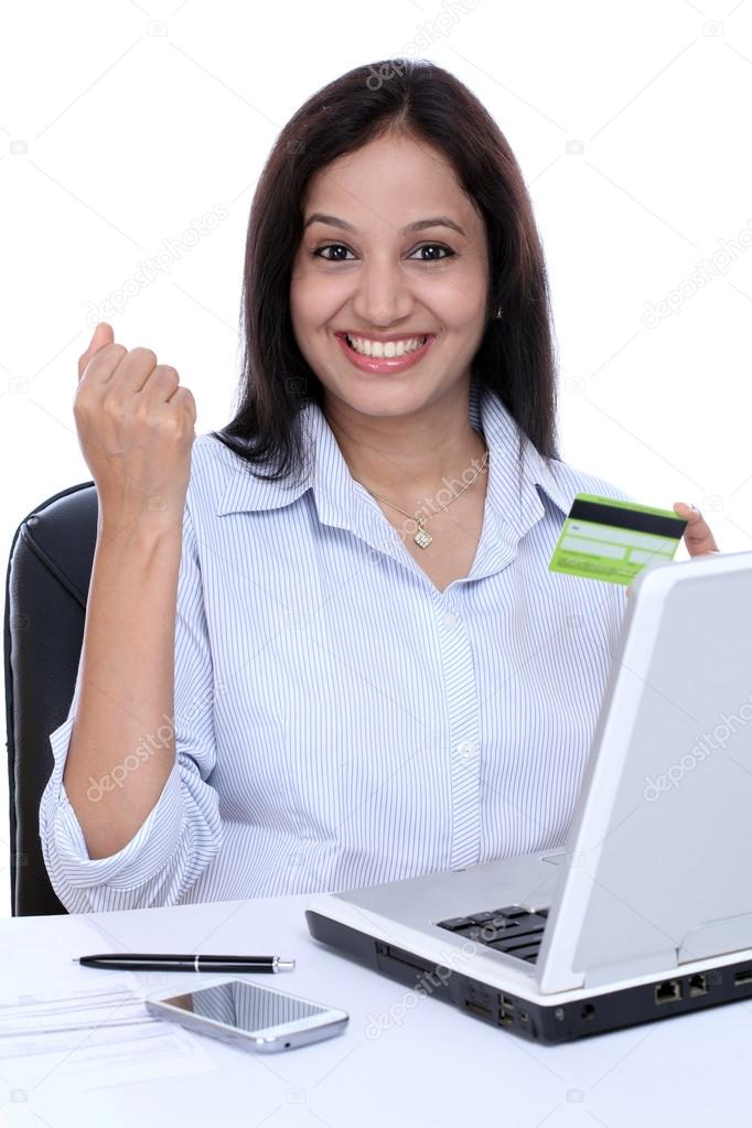 Happy young business woman doing online shopping 
