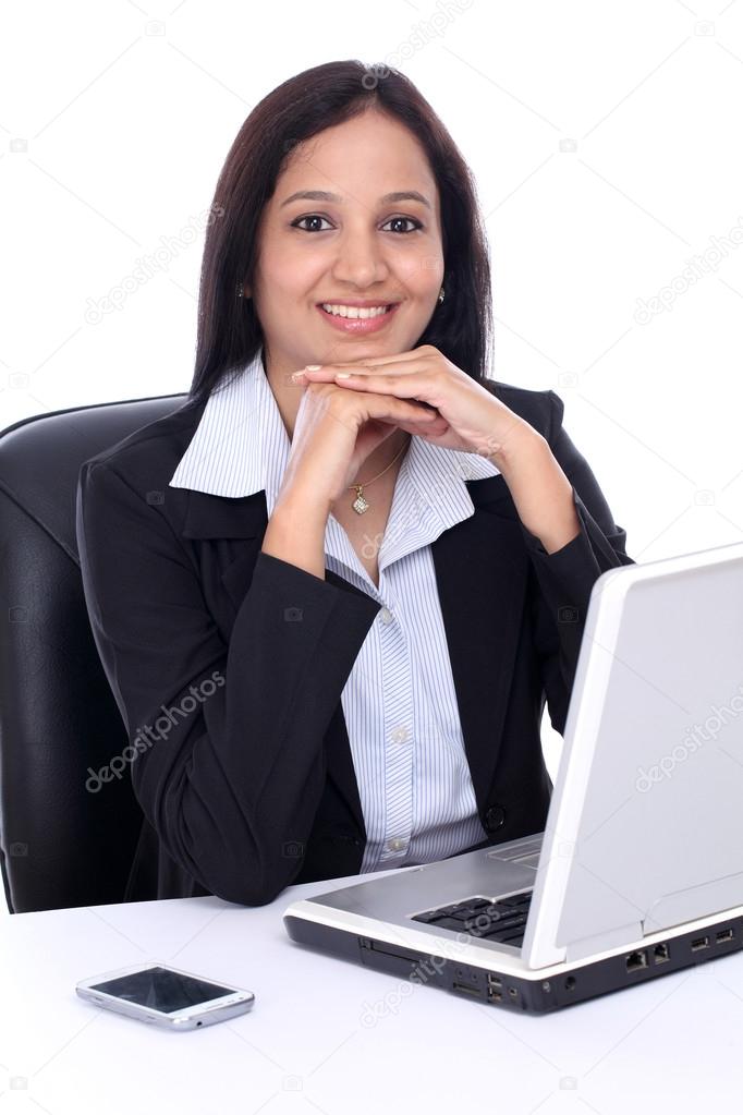 Happy young Indian business woman against white