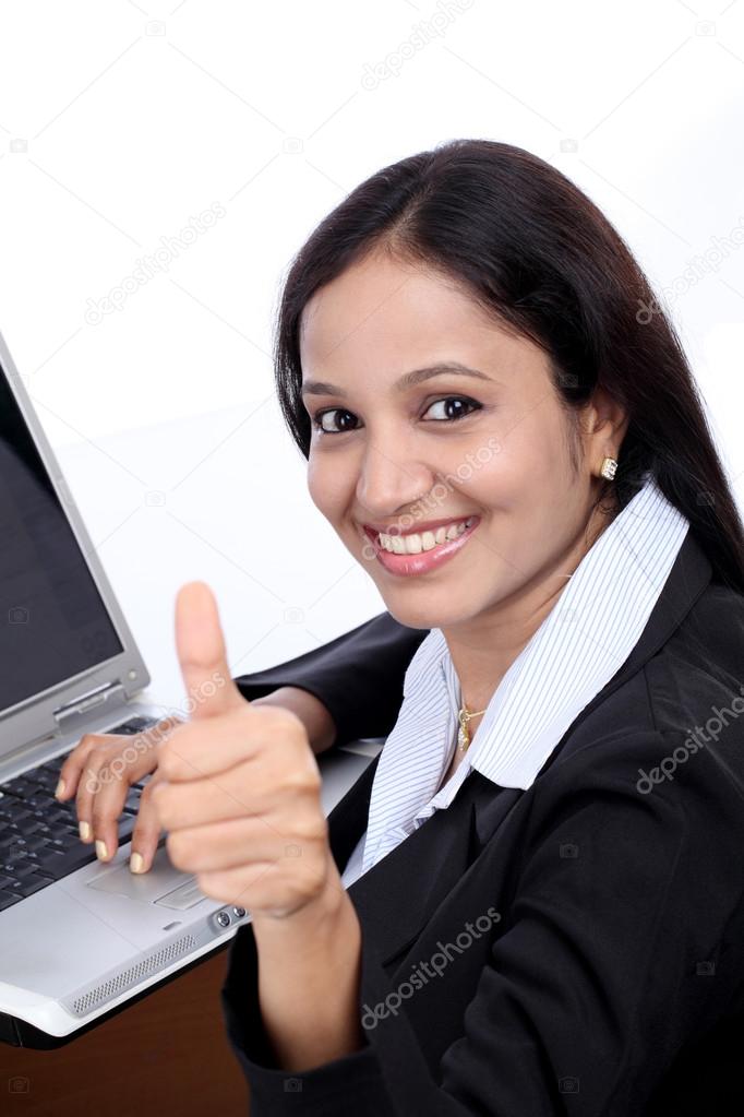 Happy young buisiness woman showing thumbs up 