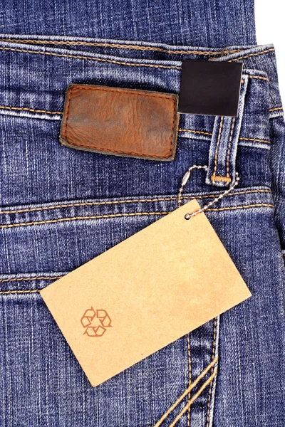 Бумажная бирка на джинсах — стоковое фото