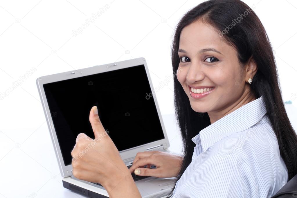 Happy young buisiness woman showing thumbs up 