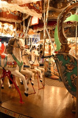 Festive carousel in a holiday park. Merry-go-round with horses.