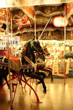 Festive carousel in a holiday park. Merry-go-round with horses.