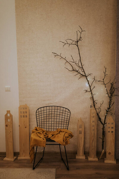 Modern and minimalist corner with a chair in Christmas decor.