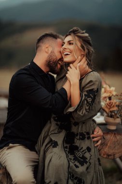 A happy couple hugging and smiling spending time at their intimate wedding