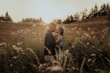 Young couple in love enjoying the beautiful nature. Intimate engagement session.