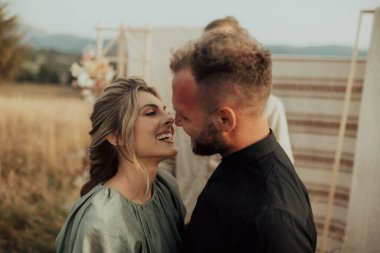 A young couple kissing and congratulating each other at the end of the wedding ceremony