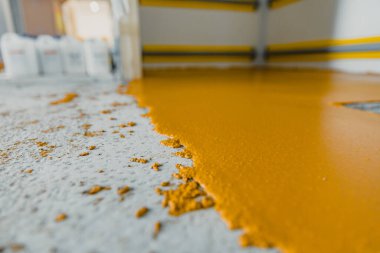 Selective focus on the yellow floor of freshly applied epoxy mortar system clipart