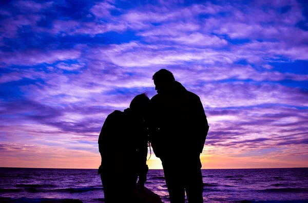 couple silhouette with colourful sky clouds for background