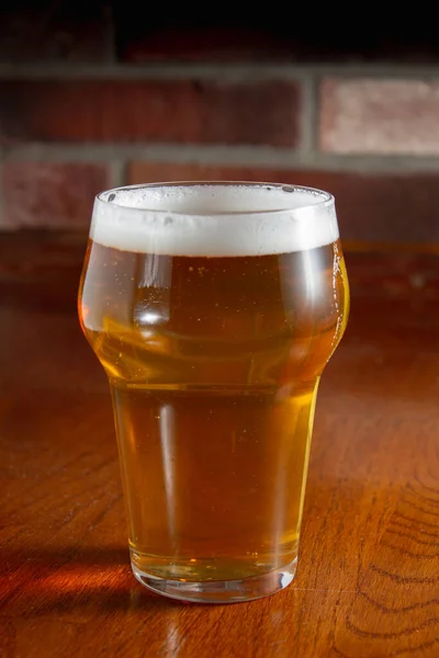 Tahta masada bir bardak light bira.