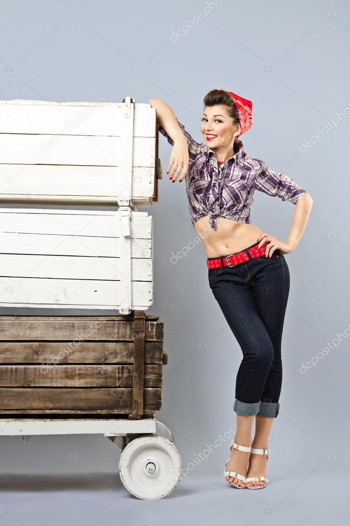 Funny pin-up girl storekeeper, stands with trolley