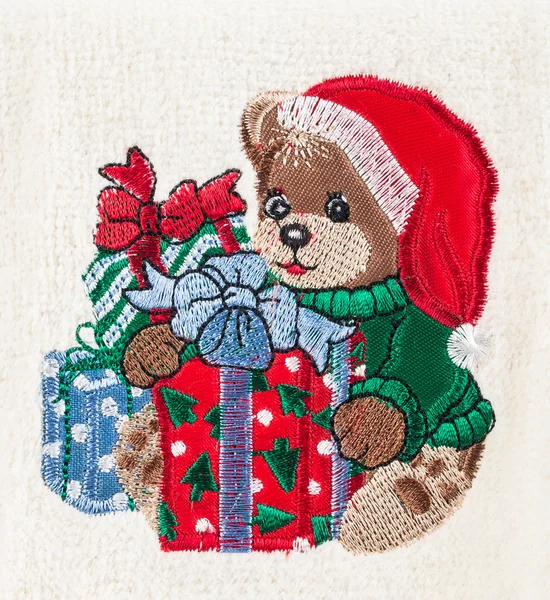Little brown bear with christmas hat and gift boxes — Stock Photo, Image