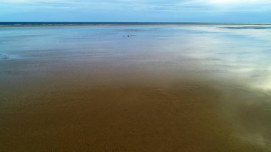 Kıyı şeridinde beyaz kumdan dağları olan güzel bir göl.
