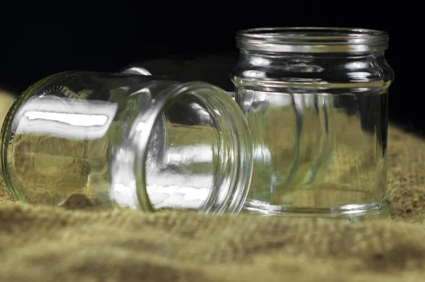 Glass jars on a black background for storing food for the winter — Stock Image Glass Jars Black Background Storing Food Winter Royalty Free Stock Photos