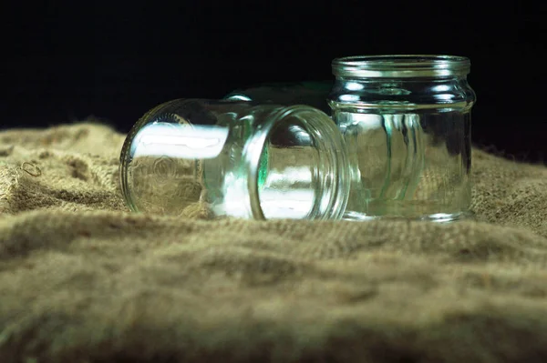 Glass jars on a black background for storing food for the winter — Stock Image Glass Jars Black Background Storing Food Winter Stock Picture