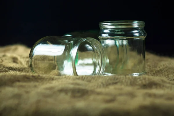 Glass jars on a black background for storing food for the winter — Stock Image Glass Jars Black Background Storing Food Winter Stock Picture