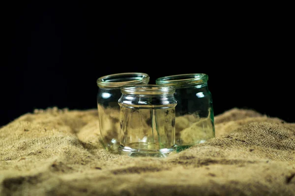 Glass jars on a black background for storing food for the winter — Stock Image Glass Jars Black Background Storing Food Winter Royalty Free Stock Photos
