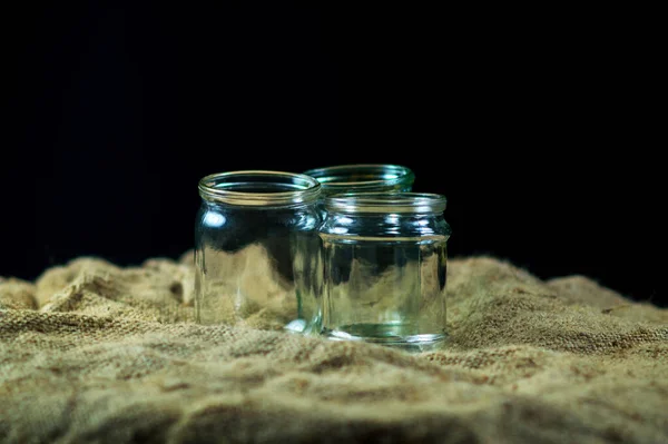 Glass jars on a black background for storing food for the winter — Stock Image Glass Jars Black Background Storing Food Winter Royalty Free Stock Images