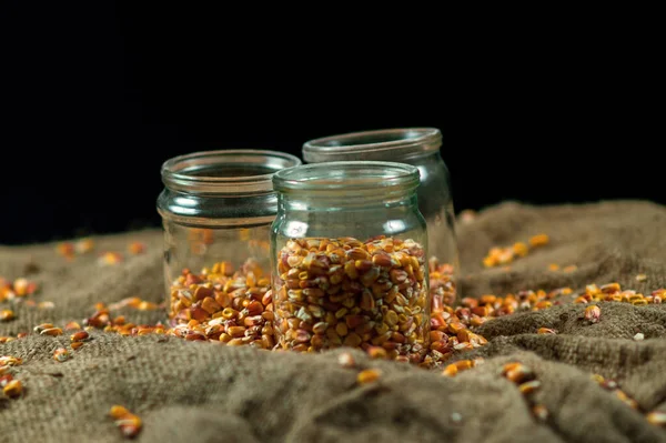 Glass jars on a black background for storing food for the winter — Stock Image Glass Jars Black Background Storing Food Winter Stock Picture