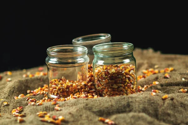 Glass jars on a black background for storing food for the winter — Stock Image Glass Jars Black Background Storing Food Winter Stock Image