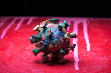 Kırmızı zemin üzerinde plasticine coronavirus 'un soyut çok renkli figürleri
