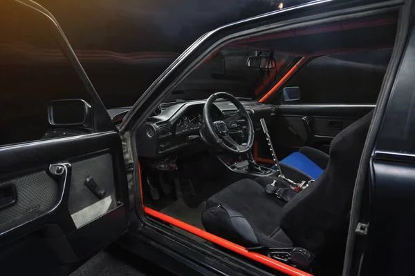 sports car interior with roll cage and drift handbrake night photography