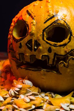 art scary Halloween with pumpkins and an old kerosene lamp in a red light preparation for the celebration in a dark room