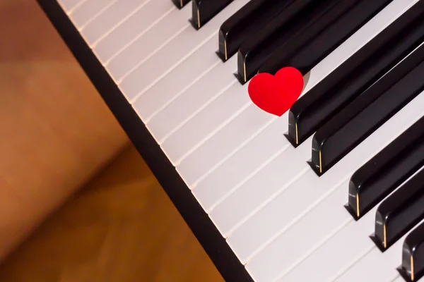 Red heart over piano keyboard