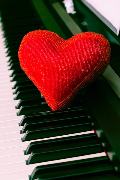 Red heart over piano keyboard