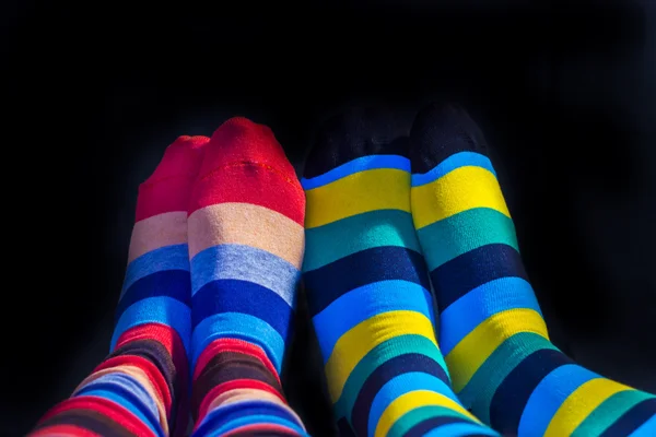 Colored socks on Valentine couple feet — Stock Photo, Image