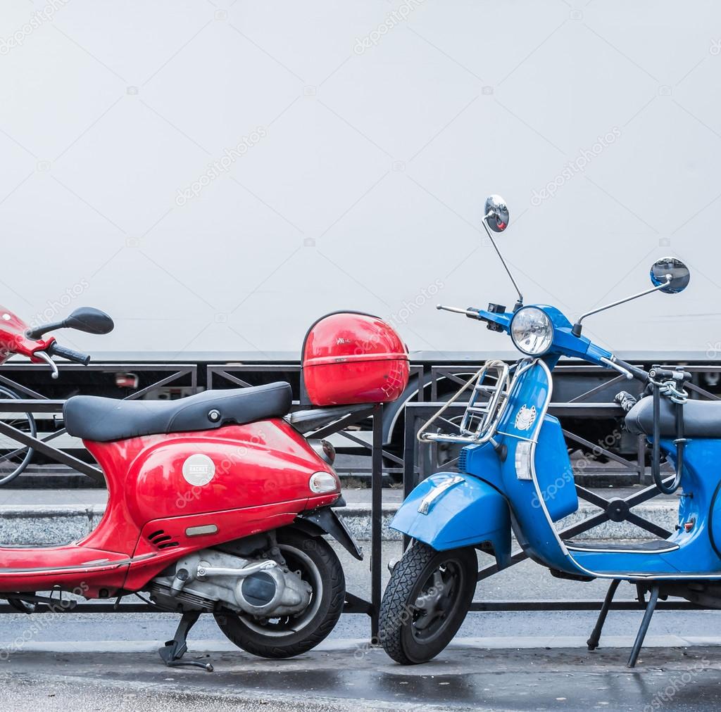 Blue and red scooters over blurry white track symbol of blue, white and red France flag