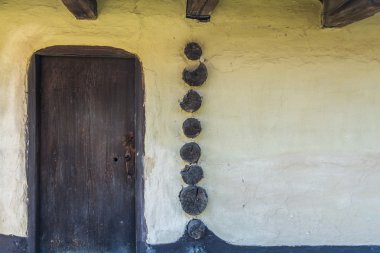 Close-up detail on wooden door and structure elements.