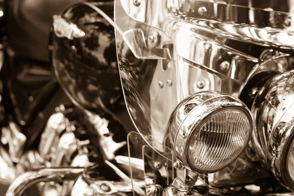 Brilliant headlight motorcycle on a blurry black and white background — Stock Photo, Image