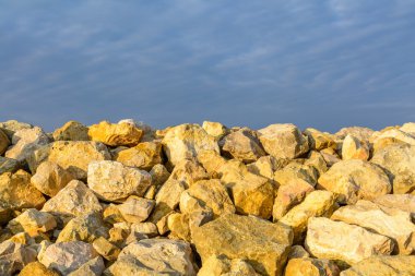 Sky and several yellow rocks. Backgroung with clear blue sky mee