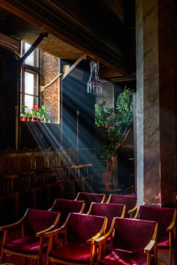 Sun rays over church window inside. A dim old church interior li