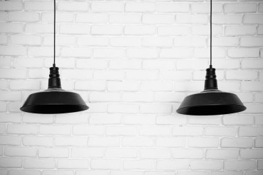 Black ceiling lamps vector. Two black ceiling lamps, light betwe