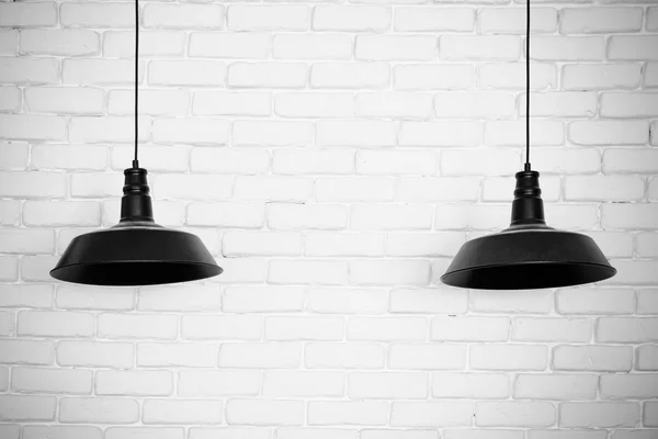 Black ceiling lamps vector. Two black ceiling lamps, light betwe