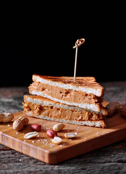Sandwich with peanut butter on a wooden table. — Stock Photo, Image