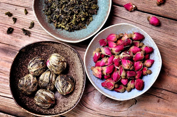 Different flower tea on a wooden background, vintage style. — Stock Photo, Image