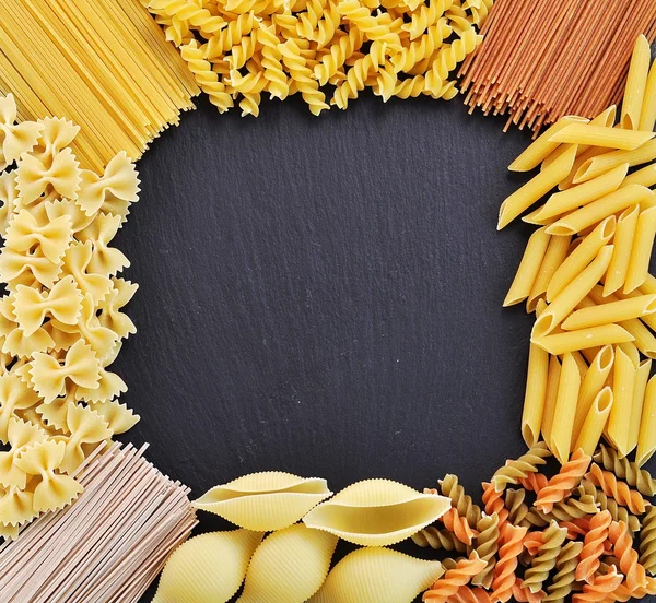 Mixed raw pasta background — Stock Photo, Image