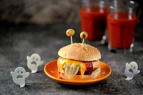 Funny monster burgers with chicken, tomato, cucumber, toast cheese and olive eyes. Food for Halloween.