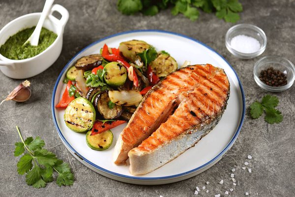 Grilled salmon steak with grilled salad of zucchini, eggplant, bell peppers, onions, garlic, cilantro, olive oil and wine vinegar.