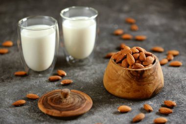 Badem sütlü ve bademli fındıklı gri beton arka plan. Vejetaryen yemeği.