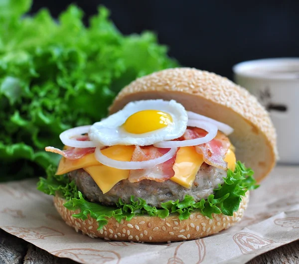 Hamburger with an egg, bacon, cheese and bow — Stock Photo, Image